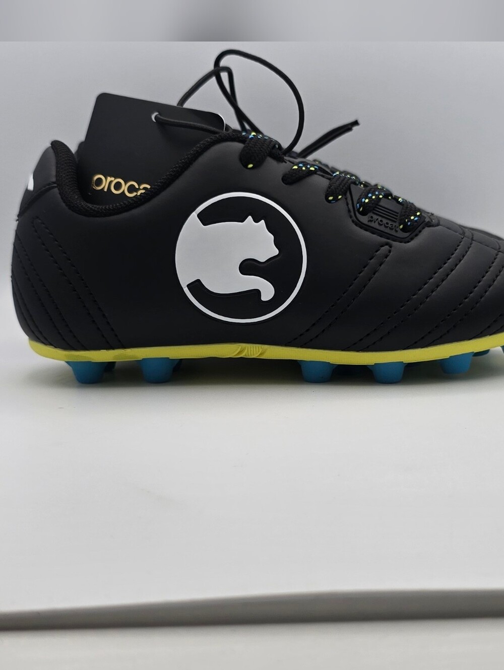 Puma Procat Kids Black Soccer Sneakers with Yellow Trim and Blue Studs